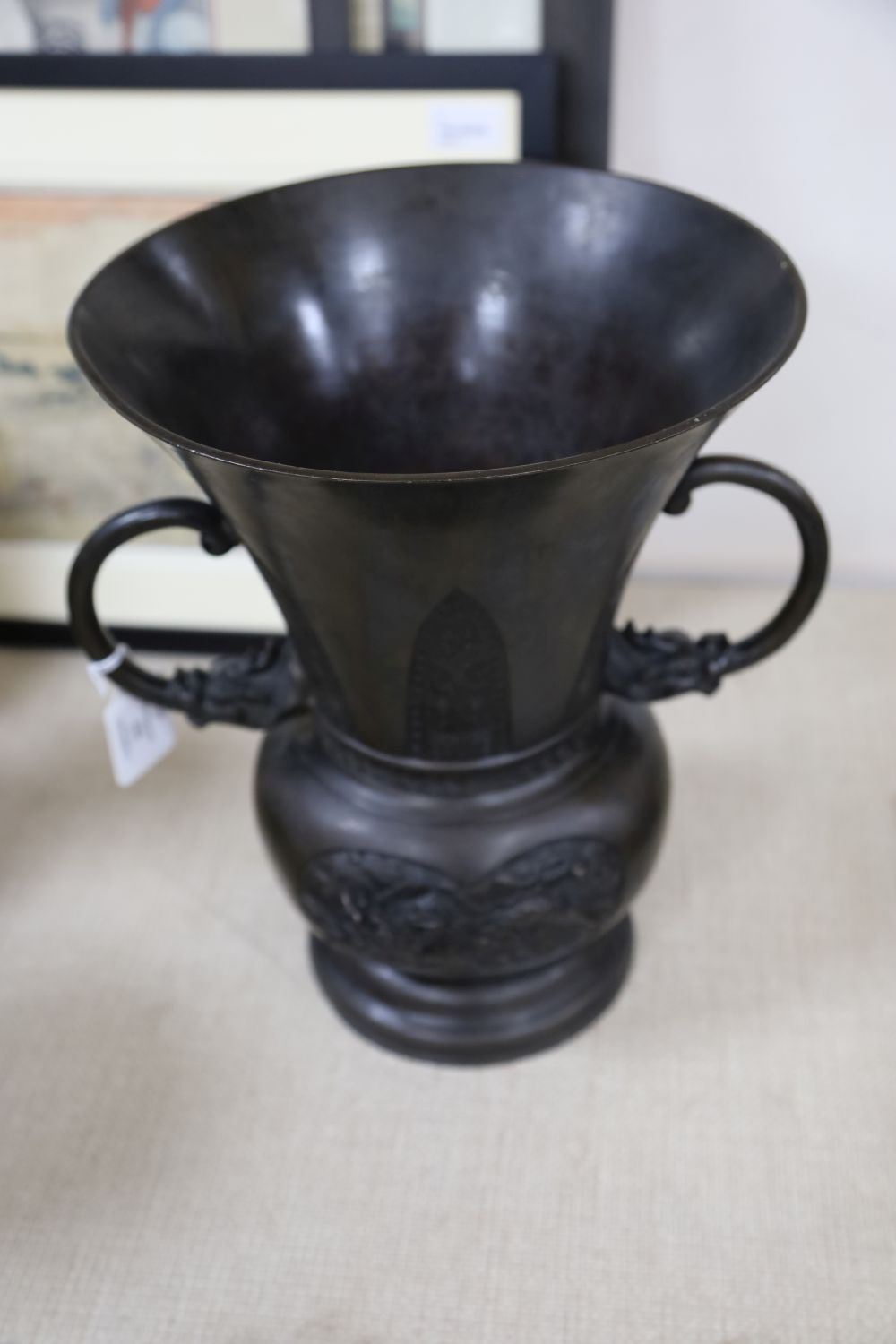 A large 19th century Japanese bronze two handled vase, cast with mythical beasts, 34cm high